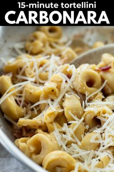 a bowl filled with pasta and cheese on top of a table