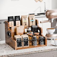 an espresso machine sitting on top of a kitchen counter next to coffee bags