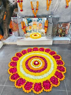 an arrangement of flowers on the ground in front of a shrine