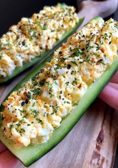 two long green peppers with cheese and herbs on them