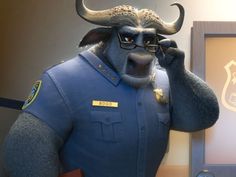 a statue of a bull wearing glasses and a police uniform is talking on the phone