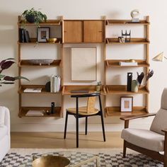 a living room filled with furniture and bookshelves next to a wall mounted shelf