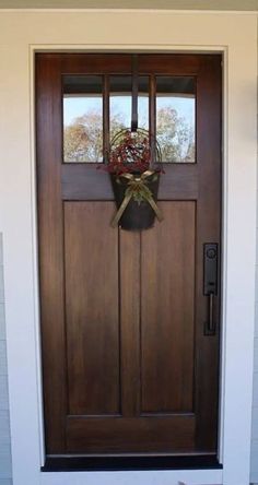 a wooden door with a wreath hanging on it