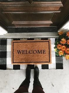 someone standing in front of a welcome mat