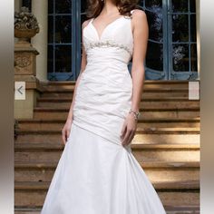 a woman in a white wedding dress standing on steps