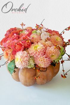 a vase filled with lots of flowers on top of a table