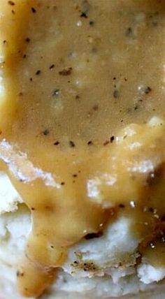 closeup of mashed potatoes covered in gravy and melted cheese on top