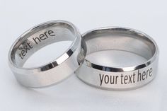 two wedding rings with the words text here and your text here engraved on each ring