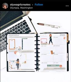 an open planner sitting on top of a desk next to a laptop