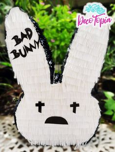 a close up of a paper cut out of a bunny face with words bad bunny on it