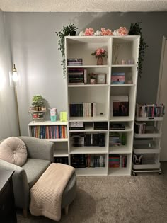 a living room filled with lots of books and furniture