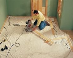 a man working on an unfinished floor with tools