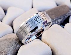 a wedding ring sitting on top of some rocks