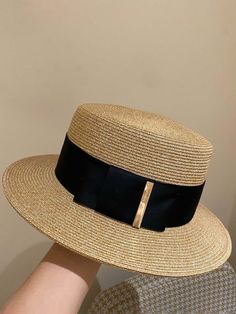 She'll be making a classy statement at the beach with this gorgeous ribbon boater hat. Decorated with a black satin ribbon with a goldtone trim, it has just the right amount of sophistication to make her summer outfits look extra chic and totally Insta-ready! Versatile look makes it super easy to dress up or dress down, depending on the occasion. The perfect accessory to add a pop of color and character to her outfits! Looks great with casual clothes, dressy outfits, beach wear, and more Boater hat with black satin ribbon accent and goldtone trim One size fits most kids Pool Hat, Neutral Hats, British Hats, Vintage Straw Hat, Womens Beach Hat, Womens Straw Hats, Soft Hats, Boater Hat, French Women