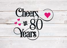 cheers is 80 years with hearts in the center on a white wood background, and black lettering