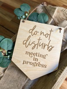 a wooden sign that says don't disturb, meeting in progress