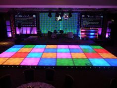 an illuminated dance floor in the middle of a room