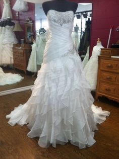 a wedding dress on display in a store