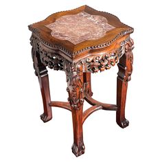 an ornate wooden table with carved wood and glass top, on white backround