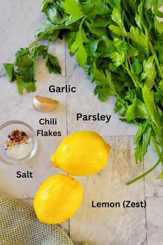 lemons, parsley, garlic, parsley and salt on a marble table