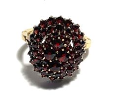 "Vintage 14K Yellow Gold Oval Bohemian Garnet Cluster Ring Victorian style Fifty-four deep burgundy colored round rose cut garnets create a gleaming cluster, fifty smaller round garnets surround the top four larger garnets. Simple adjustable band with split shoulders completes this gorgeous ring reminiscent of Victorian style. Band hallmarked \"14K\". Condition: Excellent Vintage Condition.  Dimensions: Ring Size: 8.5, Personalized adjustable band. Ring measure: garnet cluster 0.78\" (20mm) x 0.6\" (15mm), band width 1/16\" (2.5mm) on the center back. Weight: 6.97 grams." Fine Jewelry Garnet Cluster Ring, Fine Jewelry Round Cluster Ring With Garnet, Heirloom Style Round Garnet Cluster Ring, Heirloom Style Garnet Cluster Ring, Heirloom Garnet Cluster Ring, Formal Round Garnet Cluster Ring, Heirloom Oval Garnet Cluster Ring, Classic Oval Garnet Cluster Ring, Gold Oval Garnet Cluster Ring