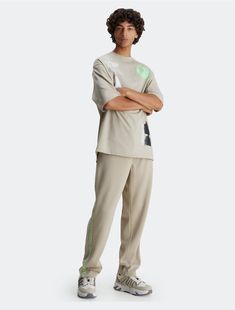 Detailed with signature logo tape along the sides, these essential sweatpants are crafted from a recycled polyester blend for reduced environmental impact. Designed with button pockets at both sides.  Material: 60% Recycled Polyester, 40% Polyester. Casual Calvin Klein Relaxed Fit Pants, Calvin Klein Relaxed Fit Cotton Pants, Calvin Klein Casual Loungewear Pants, Calvin Klein Casual Sport Bottoms, Calvin Klein Sporty Bottoms For Sports, Calvin Klein Relaxed Cotton Pants, Essential Sweatpants, Taupe Color, Environmental Impact