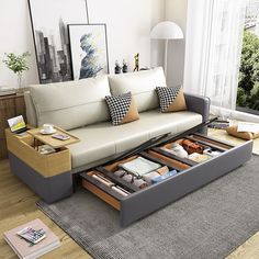 a living room with a couch, coffee table and drawers on the bottom half of it