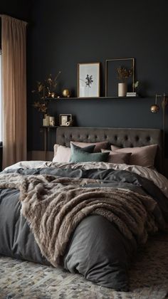 a bedroom with black walls and grey bedding