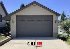 oversized garage door in bronze with second section arched windows Oversized Garage, Residential Garage Doors, Residential Garage, Overhead Garage, Garage Door Design, Door Colors