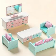 an assortment of toy furniture including a bed, dresser and chair with polka dot cushions