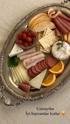 a platter filled with different types of cheese and meats