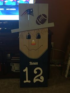 a cardboard box with a football themed face on it's head and the number 12