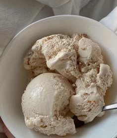 two scoops of ice cream in a white bowl