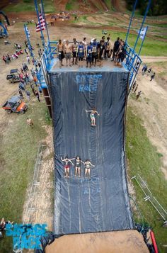 a group of people standing on top of a tarp