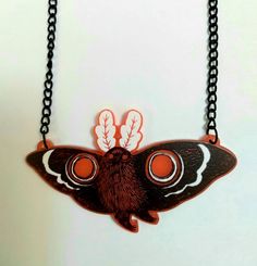 Mothman believes in you! Wear this spooky Northeastern legend around your neck as a reminder of fhd unknown, or just of how cool Mothman is. The light makes the red acrylic kind of glow a bit on a light backdrop! The black coated chain is about 18 inches and the charm is 2 inches. If you know that is too short, let me know and I can add a few inches, but this size fits most necks really well--and you can easily shorten it yourself! My acrylic and wood charms are printed/laser cut by Ink It Labs Handmade Black Plastic Jewelry, Red Resin Novelty Jewelry, Novelty Red Resin Jewelry, Black Plastic Jewelry Gift, Handmade Red Halloween Necklaces, Red Novelty Plastic Jewelry, Handmade Red Necklaces For Halloween, Novelty Red Plastic Jewelry, Wood Charms