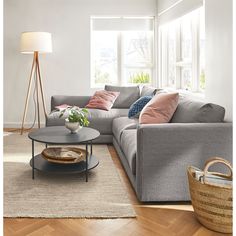 a living room filled with lots of furniture and a lamp on top of a table