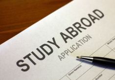 a study abroad application with a pen resting on it