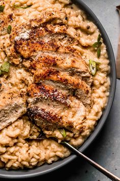 some meat and rice in a bowl on a table