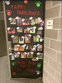 a door decorated with pictures and paw prints for the paws to you day event in front of a brick wall