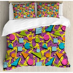 a bed with colorful patterns and pillows on it