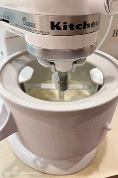 a white kitchen mixer sitting on top of a counter