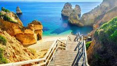 stairs leading down to the beach and ocean with cliffs in the background, cantaloupe beach, algares, portugal