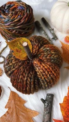 yarn and autumn leaves are laid out on the table