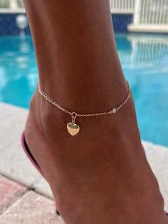 Lovely puffy heart anklet decorated with a diamond on the side and a diamond at the clasp drop, all on a 14K Solid Gold chain. Chain and heart are both all 14k Solid Gold.  Diamonds are 0.05ct each. Please select the chain metal from the drop-down menu. Anklet length can be customized. This listing is for the Enamored Heart Anklet Only.  All other anklets are sold separately  Visit my official website www.tatirocks.com and get 15% OFF all stock items! Use code BEACHLIFE at checkout. Coupon is valid only on my official website, NOT this Etsy site. * All photos are property of TatiRocks Jewelry. Use of these photos is prohibited unless permission is granted by TatiRocks Jewelry. Heart-shaped Anklets For Valentine's Day, Elegant Gold Anklets With Heart Charm, Adjustable Heart Charm Anklets, Elegant Heart-shaped Anklets For Valentine's Day, Elegant Heart Charm Anklets For Valentine's Day, Elegant Heart-shaped Anklets For Wedding, Elegant Wedding Anklets For Valentine's Day, Elegant Wedding Anklets, Elegant Adjustable Anklets With Heart Charm