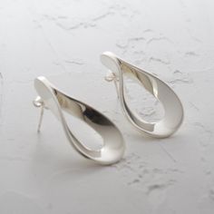 Flat Teardrop Sterling Silver Earrings These unusual sterling silver stud earrings are totally unique, very modern and will go with every outfit.  An amazing wedding gift or special birthday present, these striking Flat Teardrop earrings are perfect for making a bold statement. Take a look at our matching Flat Teardrop Pendant... https://www.etsy.com/uk/listing/268607145/ Specification: Type: Stud Earring Material: 925 Sterling Silver Dimensions:  H: 35mm W: 22mm  * All items are beautifully pac Modern Silver Wedding Earrings, Modern Teardrop Earrings For Gift, Contemporary Silver Drop Earrings, Modern Dangle Teardrop Earrings For Anniversary, Modern Teardrop Earrings For Anniversary, Modern Sterling Silver Teardrop Earrings For Formal Events, Modern Sterling Silver Teardrop Earrings For Formal Occasions, Modern Silver Earrings For Anniversary, Silver Teardrop Earrings With Polished Finish For Gift