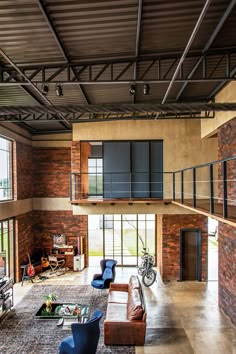 a living room filled with furniture and lots of windows