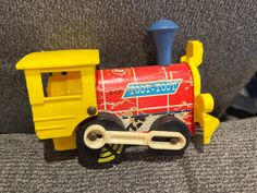 a toy train is sitting on the couch with its wheels still attached to it's side