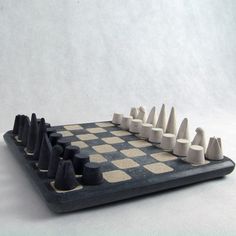 a black and white chess board with pieces arranged on the board, ready to play