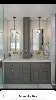 a large bathroom with two sinks and mirrors