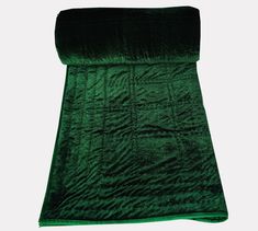 the green blanket is folded on top of it